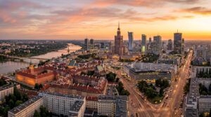 A professional, high-angle panoramic view of the Warsaw skyline at golden hour, showcasing the city'