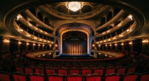A high-quality, atmospheric editorial photograph of a historic Warsaw theater interior with glowing